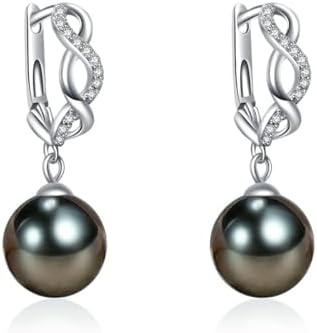 Classic round pearl stud earrings gleaming softly on a display.